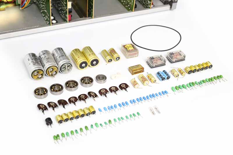 Ausgebaute Kondensatoren, Relais, Kugellager, Trimmpotentiometer und Riemen aus einer REVOX Bandmaschine